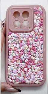 Finished DIY iPhone case with pink frame, decorated with dense mini pink fruit and cute animal stickers, creating a sweet pastel kawaii aesthetic.