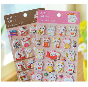 Display of multi-color "Fortune Cat" 3D puffy stickers, showing various cute lucky cat designs in different color schemes.