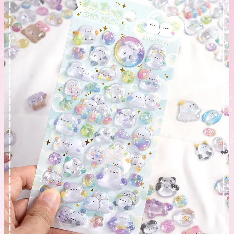 Handheld display of 3D crystal puffy sticker sheets with cute ghost and small animal designs, featuring iridescent and glitter effects
