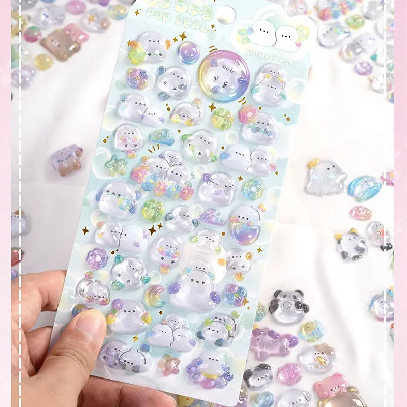 Handheld display of 3D crystal puffy ghost pet sticker sheet, featuring cute ghost designs with iridescent and glitter effects

