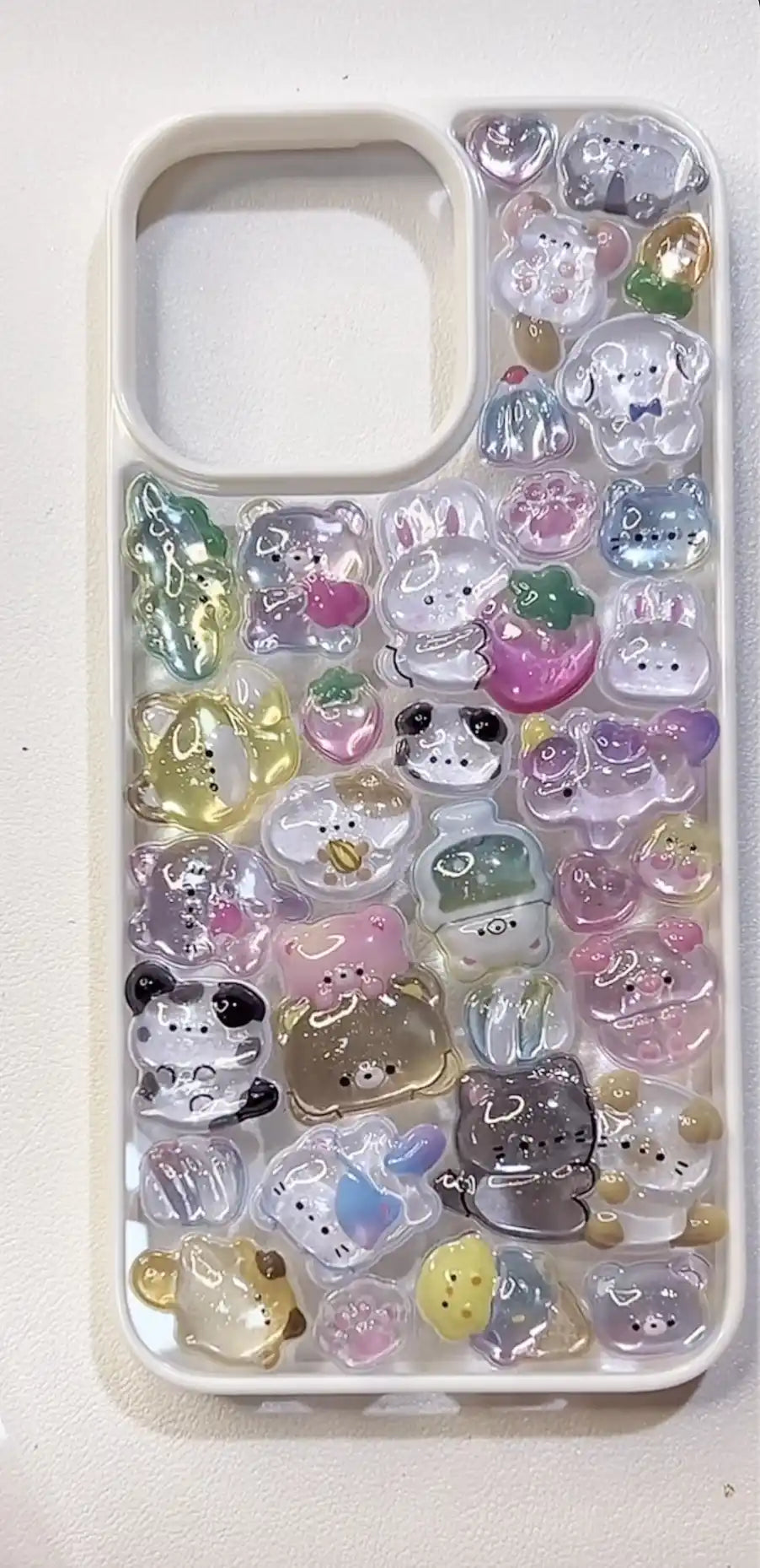 Finished handmade DIY phone case covered in colorful 3D resin animal charms including pandas and rabbits, kawaii aesthetic.