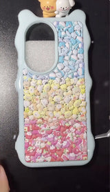 Final look of a handmade DIY phone case covered in 3D resin unicorns, moons, and stars, featuring a dreamy pastel aesthetic.