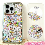 Finished display of handmade DIY phone case with full corner creature print, clear green frame, and cute mini character patterns