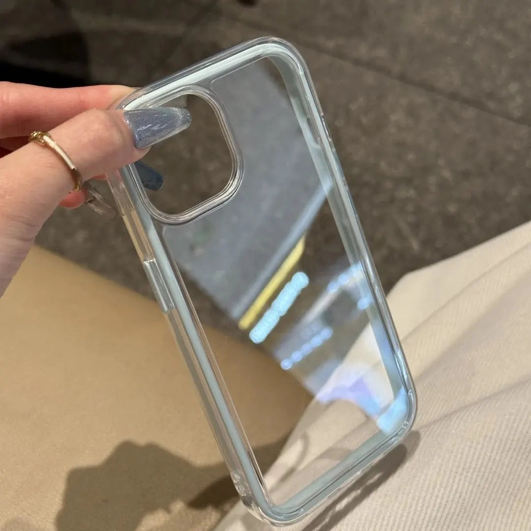 A minimalist hybrid protective phone case with a clear ice blue accent frame and a crystal clear transparent back panel, held in hand.
