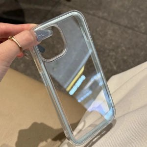 A minimalist hybrid protective phone case with a clear ice blue accent frame and a crystal clear transparent back panel, held in hand.