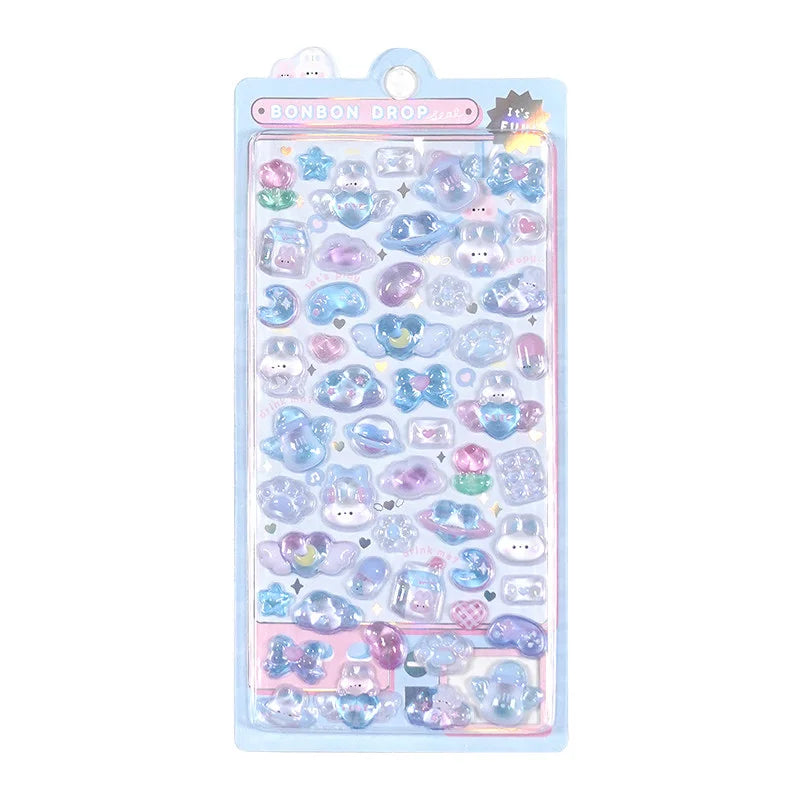 A blue retail sheet of premium Bonbon Drop Seal 3D puffy stickers with a dreamy celestial theme, featuring cute cartoon bunnies, hearts, milk bottles, and angel wings.