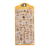 A retail sheet of premium Bonbon Drop Seal 3D glossy stickers with a delicious snack theme, featuring cute cartoon cats shaped like bread, donuts, and cupcakes.