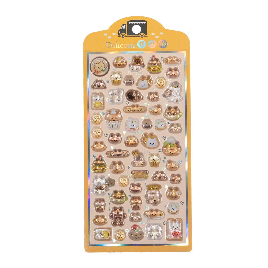 A retail sheet of premium Bonbon Drop Seal 3D glossy stickers with a delicious snack theme, featuring cute cartoon cats shaped like bread, donuts, and cupcakes.