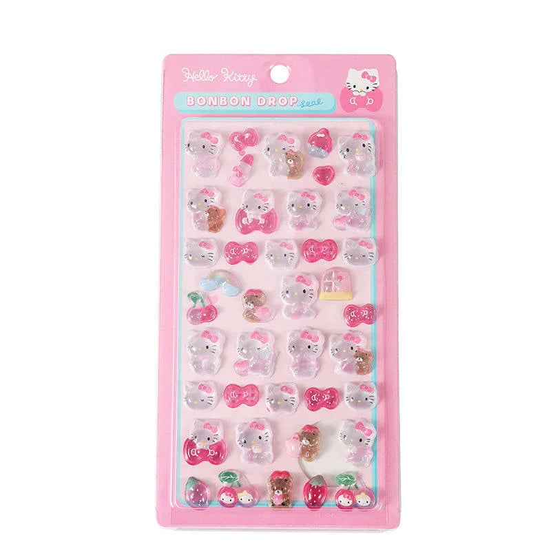 A pink retail pack of Hello Kitty Bonbon Drop Seal 3D glossy stickers with transparent cartoon characters and ribbons for DIY crafting.