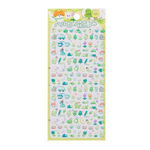 A sheet of Japanese kawaii mini puffy 3D stickers with a yellow-green spring picnic theme, featuring tiny dinosaurs, trees, and cups.