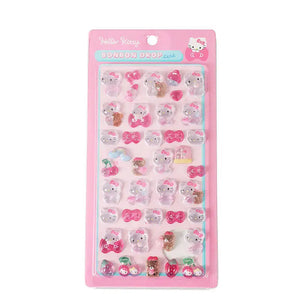 A pink retail pack of Hello Kitty Bonbon Drop Seal 3D glossy stickers with transparent cartoon characters, ribbons, and cherries for DIY crafting.