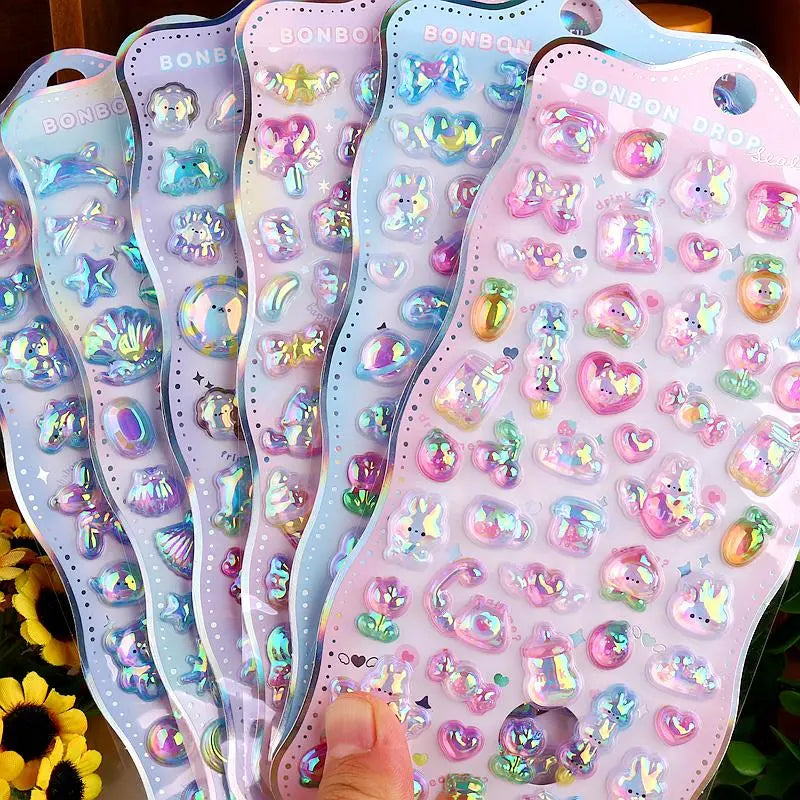 Collection of 3D crystal puffy "BONBON DROP" sticker sheets with adorable iridescent pet designs, in blue and pink pastel color schemes