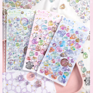 Scene display of 3D crystal puffy sticker sheets with diverse pet designs (ocean, ghost, bakery), showing versatile use for crafts
