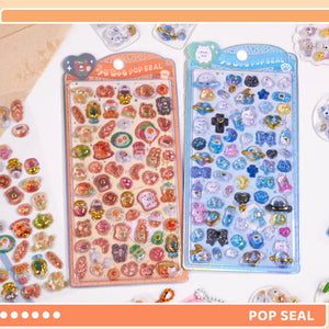 Collection of 3D crystal puffy sticker sheets with cute dessert, pet, and space designs, in orange and blue color schemes
