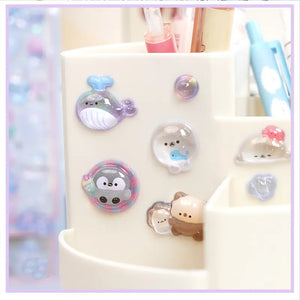 Decorative display of 3D ocean pet crystal stickers used for pen holder DIY, featuring cute whale, penguin, and seal designs with iridescent glitter effects