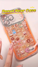 Handcrafted phone case with a neon orange border and luxury rhinestone camera lens frame, filled with a dense 3D collage of glossy cartoon donut bear and bakery charms.
