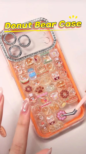 Handcrafted phone case with a neon orange border and luxury rhinestone camera lens frame, filled with a dense 3D collage of glossy cartoon donut bear and bakery charms.