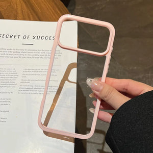 A minimalist hybrid protective phone case with a soft pastel pink border frame and a crystal clear transparent back panel, held in hand.