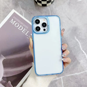 A minimalist hybrid protective phone case with a soft pastel ice blue border frame and a crystal clear transparent back panel, held in hand.