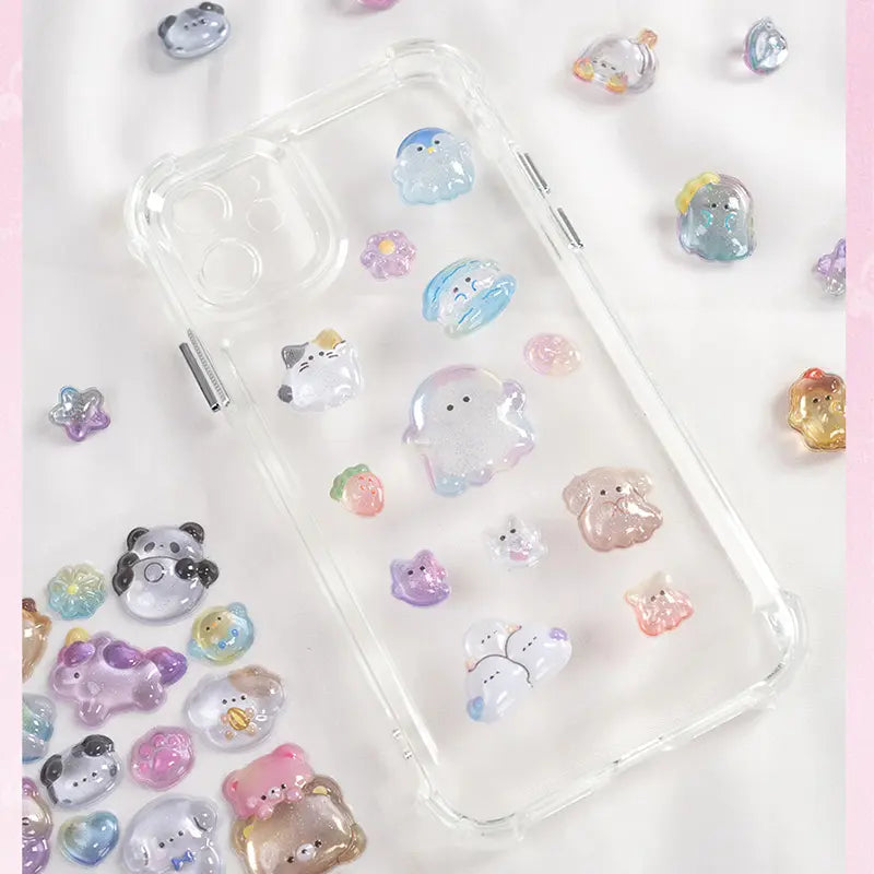 Decorative display of 3D pet crystal stickers used for phone case DIY, featuring adorable ghost, panda, and cat designs with holographic effects
