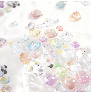 Scatter display of 3D crystal puffy pet stickers, showing diverse ghost and animal designs with glitter and iridescent effects

