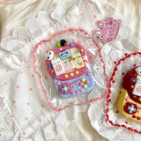 Pink and purple cat-themed game-console squishy in clear packaging.