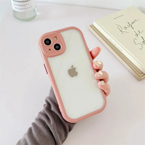Clear DIY phone case for iPhone with soft pink protective frame and transparent back panel, featuring raised camera protection, ready for sticker decoration.