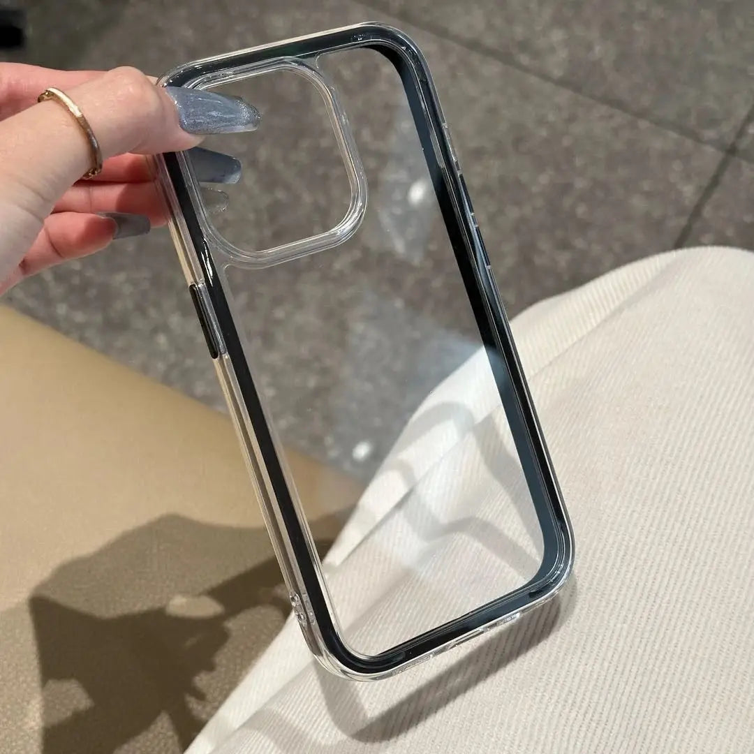 A minimalist hybrid protective phone case with a sleek translucent black border frame and a crystal clear transparent back panel, held in hand.