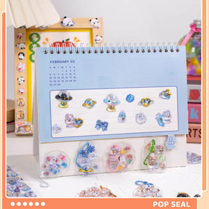 Decorative display of 3D crystal clear stickers with cute space and pet designs, used for journal and keychain DIY
