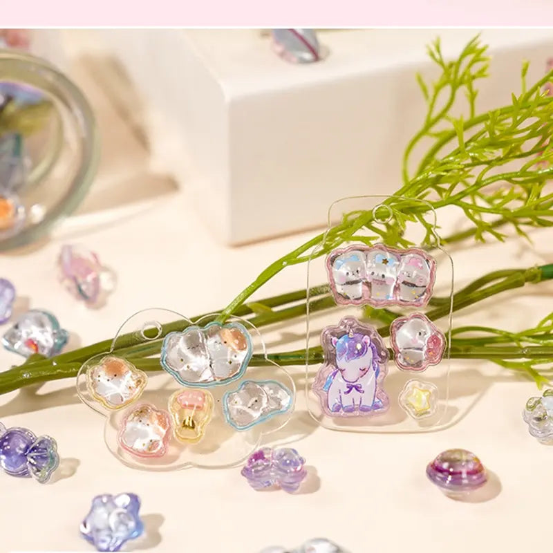 Decorative display of 3D unicorn and pet crystal stickers used for keychain DIY, featuring cute unicorn and long-tailed tit designs, perfect for gift making