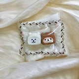 White and brown bear-hood shapes displayed together in clear packaging.